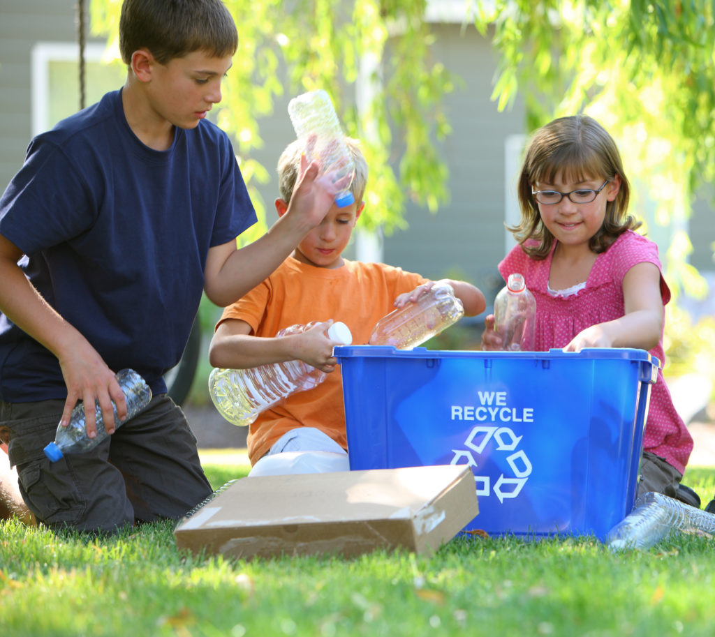 photo of children recycling water bottles