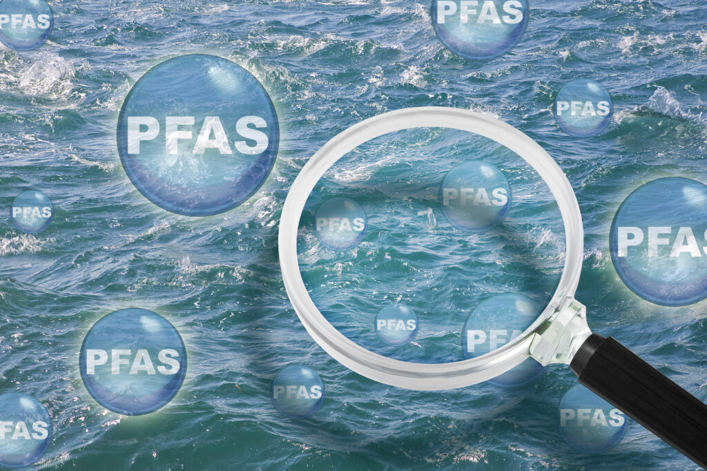 body of water with bubbles enclosing the letters PFAS overlapping the water