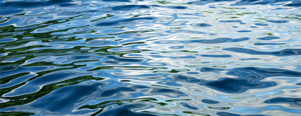 Undulating waves  of pure water reflecting light patterns.
