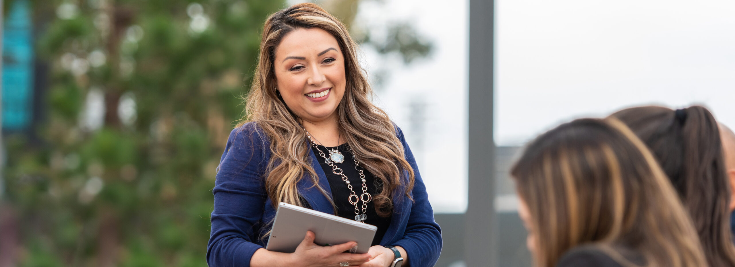 Employee talking to others in an outdoor setting