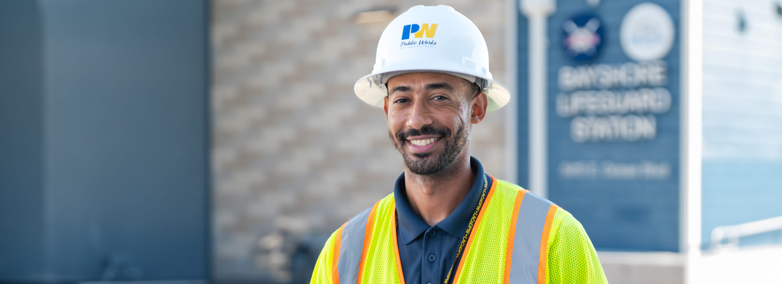 Employee wearing a hard hat and safety vest